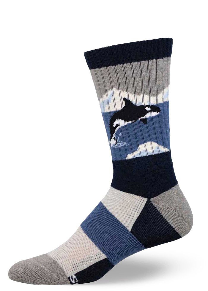 Dark blue, gray, and black hiking socks for men featuring an orca whale jumping out of the water against a mountain landscape.