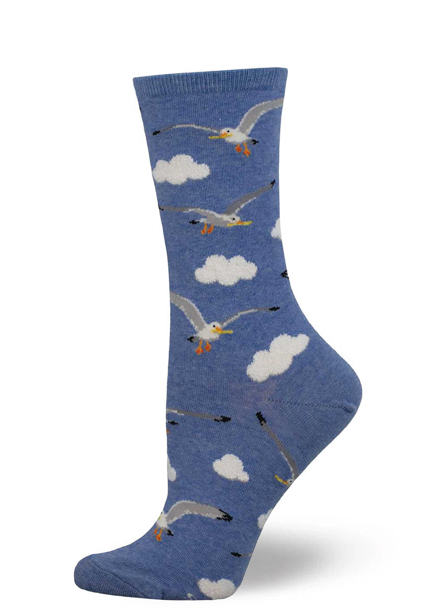 Blue crew socks for women with an allover pattern of fluffy clouds and seagulls with french fries in their beaks.